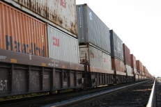Cargo on rail tracks: "Rail tracks carry container trains to and from inspection points, tracing the familiar and well-tread corridors of their home."